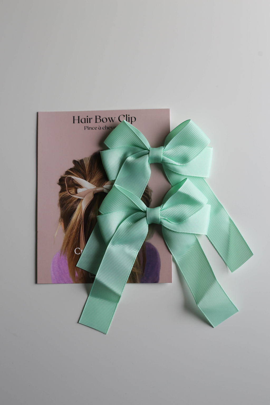 Durable metal clip detail on oversized ribbon bow, crafted for secure all-day wear.