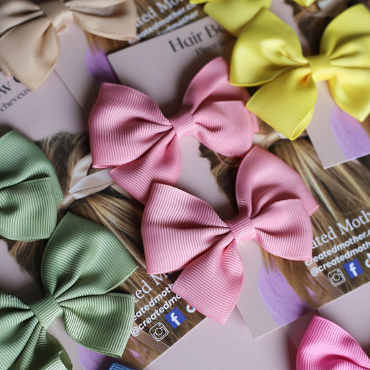 Set of colorful mini ribbon bows on display cards, perfect for retail or gift giving.