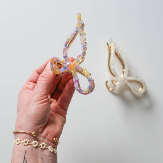 Colorful eco acetate bow hair clip on lavender base with gold-tone accents.