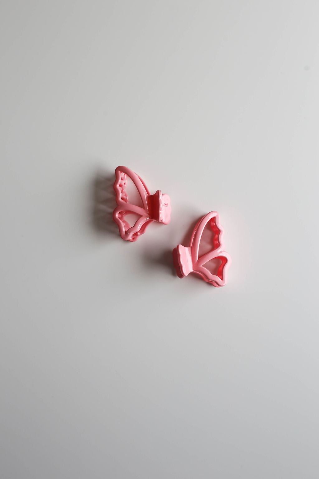 Lightweight and secure pastel clips in butterfly form for managing small hair sections.