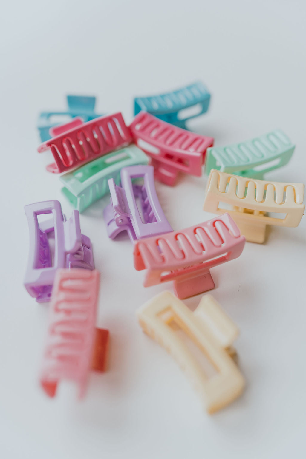 Small rectangle-shaped hair clips in delicate pastel colors.