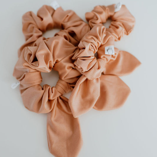 Peach swim scrunchie made from water-resistant fabric