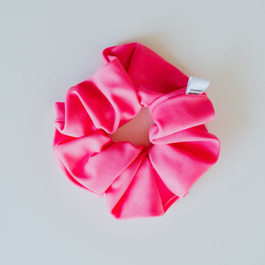 Neon pink swim scrunchie made from quick-dry fabric