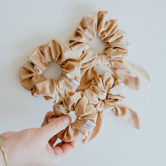 Gold swim scrunchie made from water-resistant swimsuit fabric