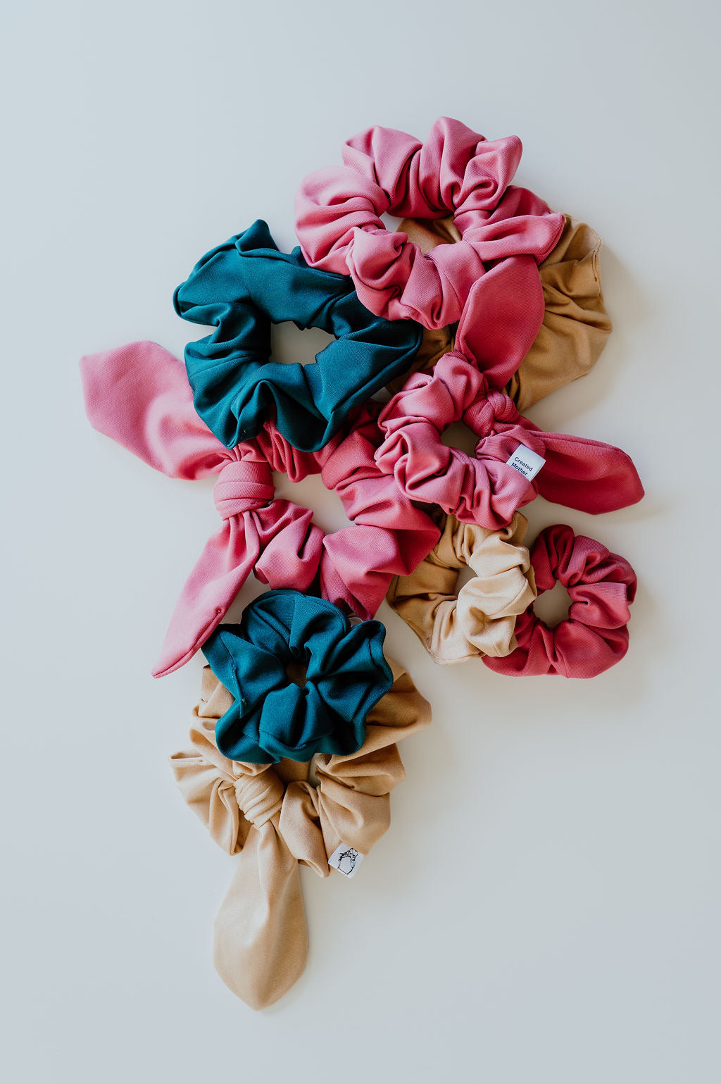 Classic and Bow Scrunchies made of swim suit material that repel water and are quick to dry!