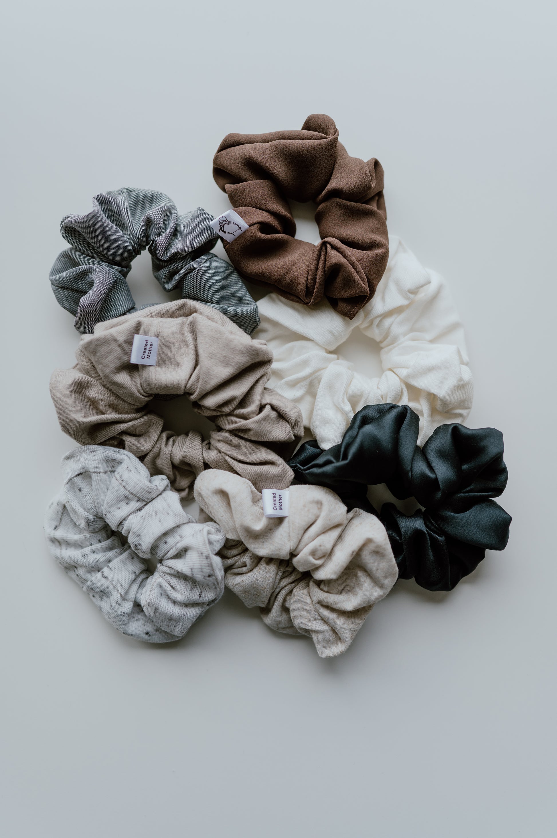 Set of colorful scrunchies on a light gray background