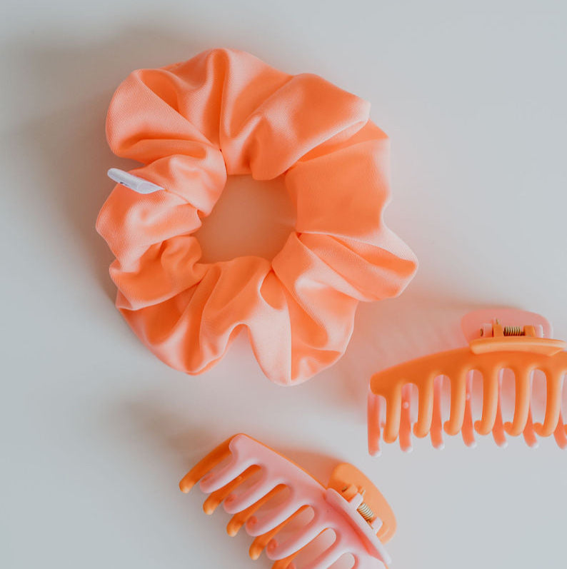 Neon peach swim scrunchie made from quick-dry fabric