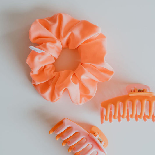 Neon peach swim scrunchie made from quick-dry fabric