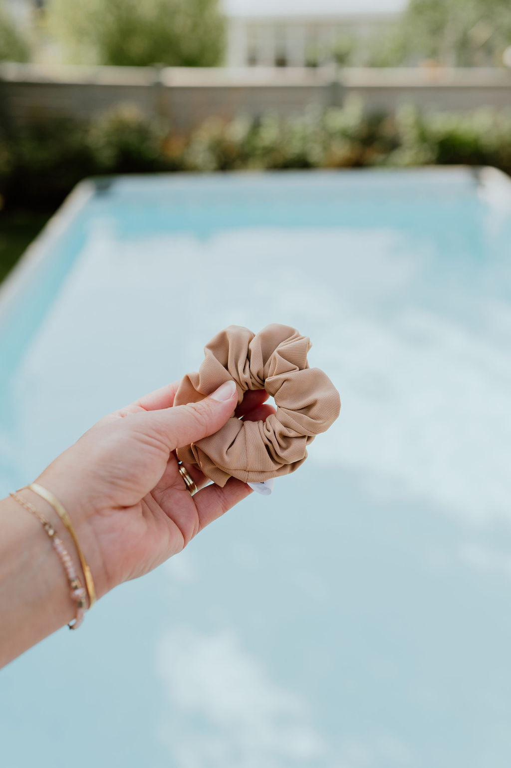 Assortment of swim scrunchies in neutral colors for versatile styling.