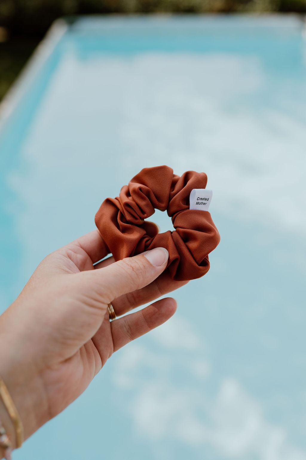 SWIM scrunchies in neutral shades, ideal for beach vacations.