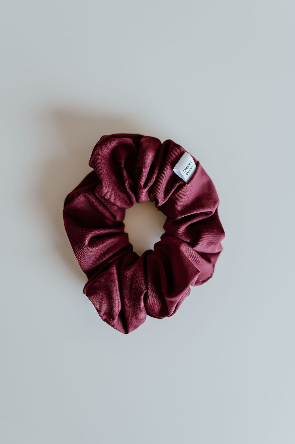 Water-resistant wine-colored scrunchie for pool and gym
