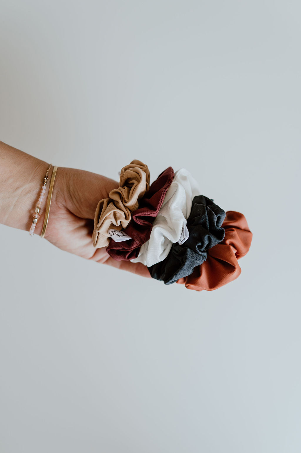 Collection of water-repellent scrunchies for poolside fun.